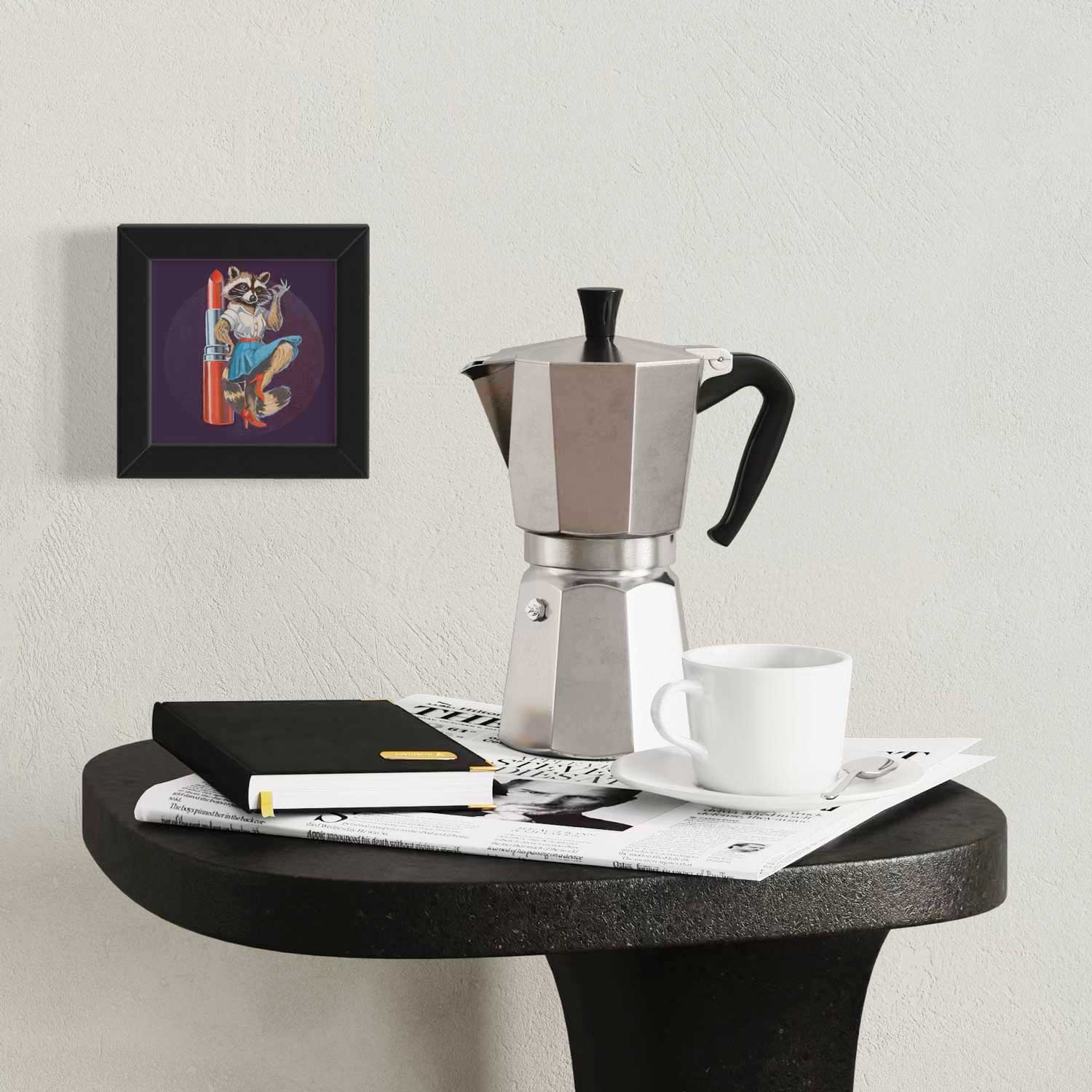 Cozy coffee corner featuring framed pocket art print and stylish coffee maker on a black table.