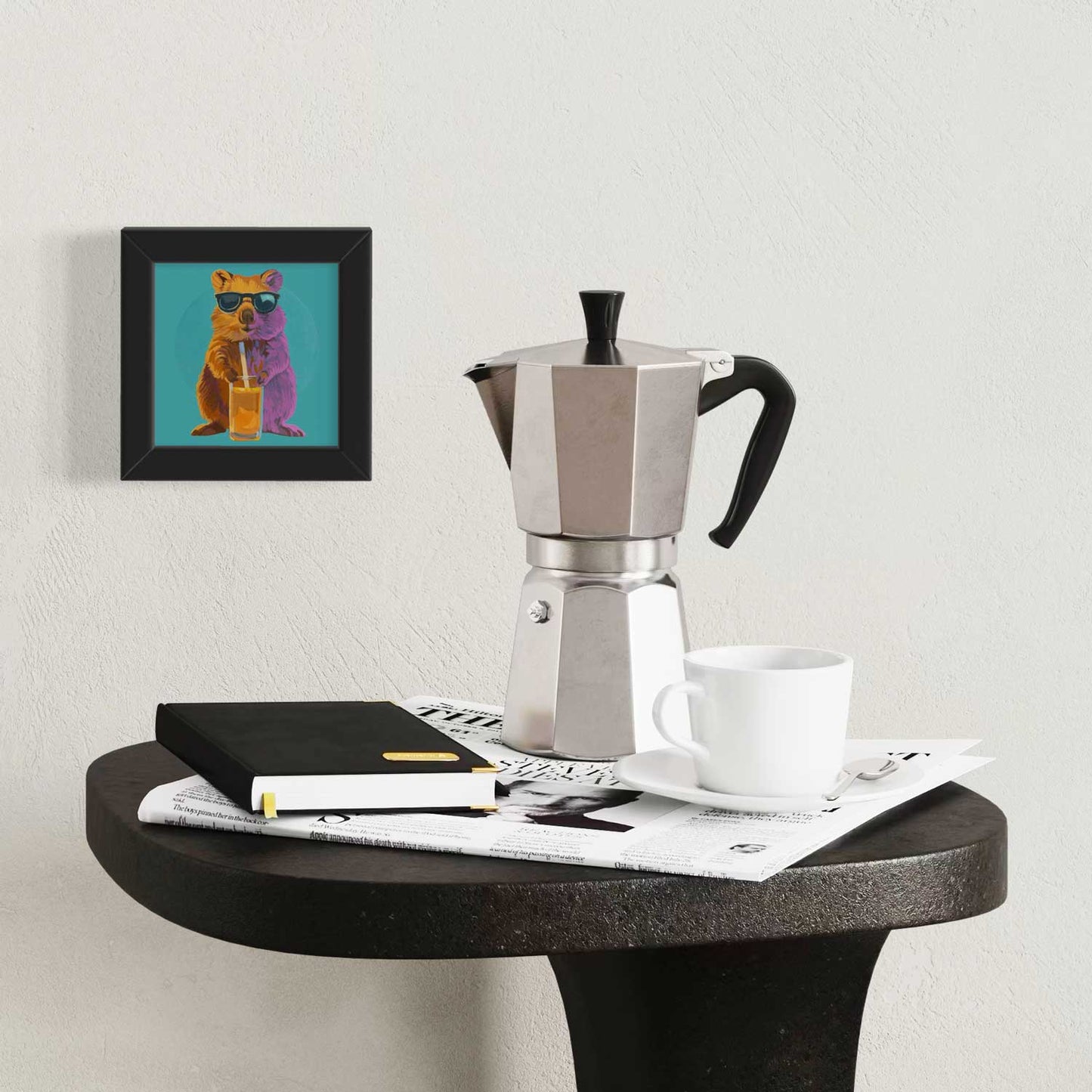 Quokka art print in a stylish frame on a table with coffee maker and notebook, adding a cute touch to any space.