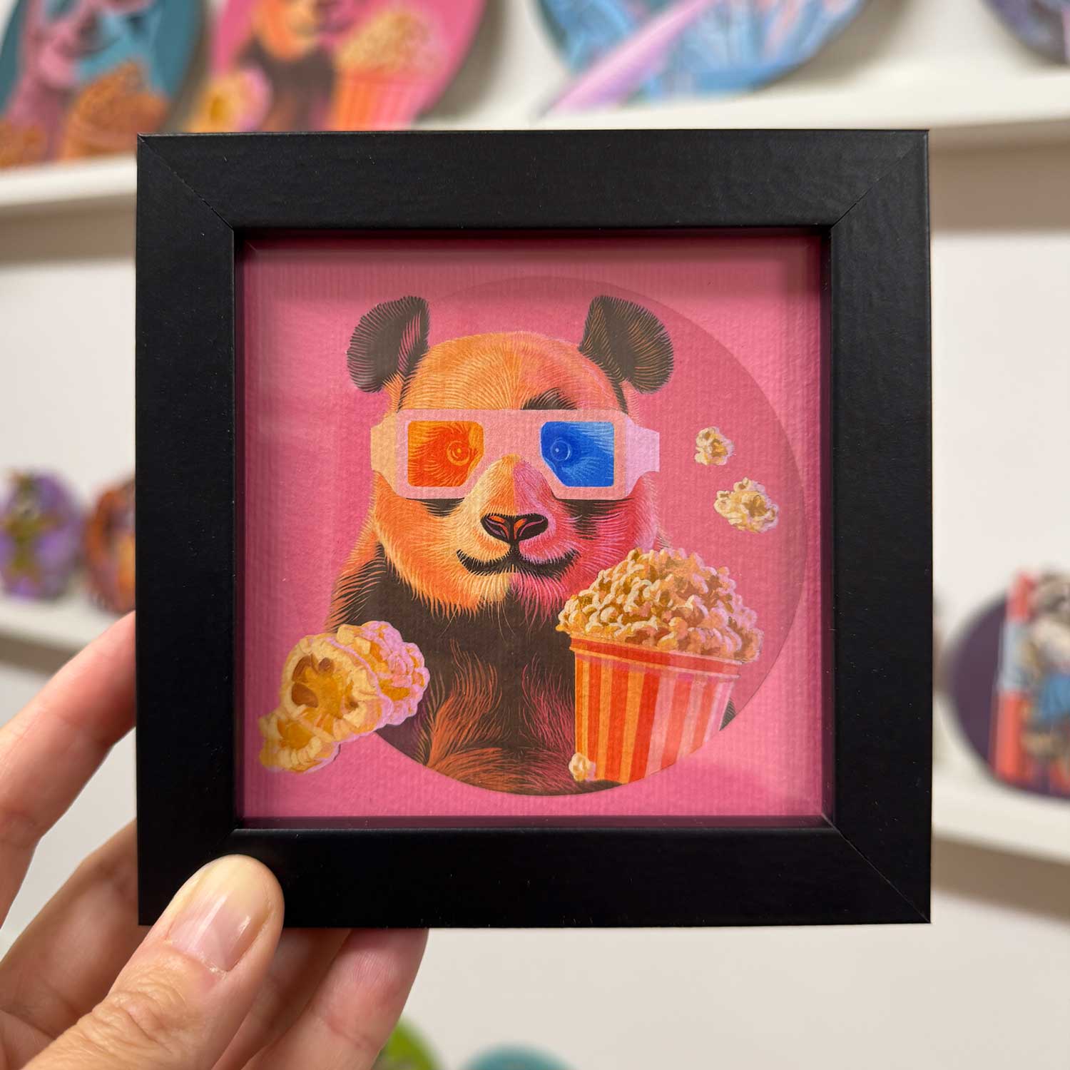 Cute popcorn panda in 3D glasses, framed in black, perfect for adding joy to any space.