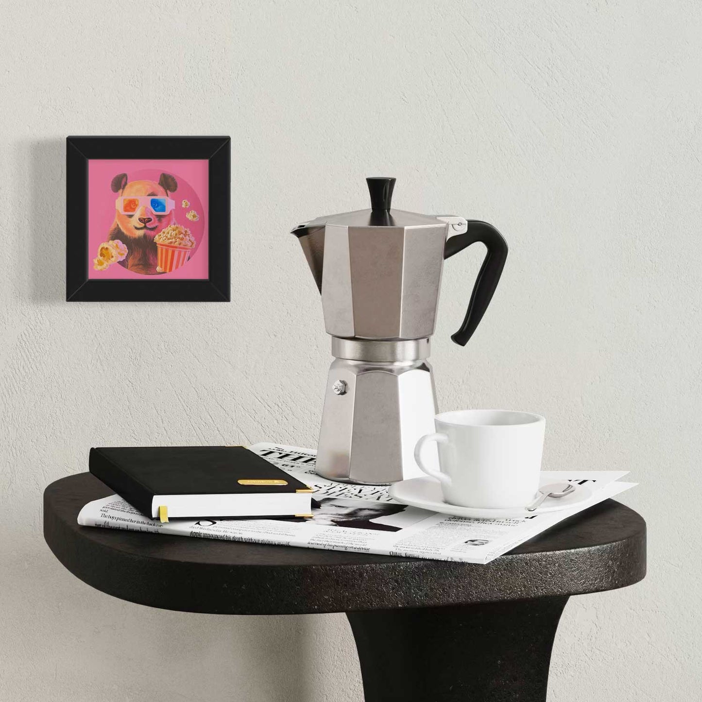 Framed Pocket Art print of a cute panda with popcorn next to a coffee maker and notebook on a stylish table.