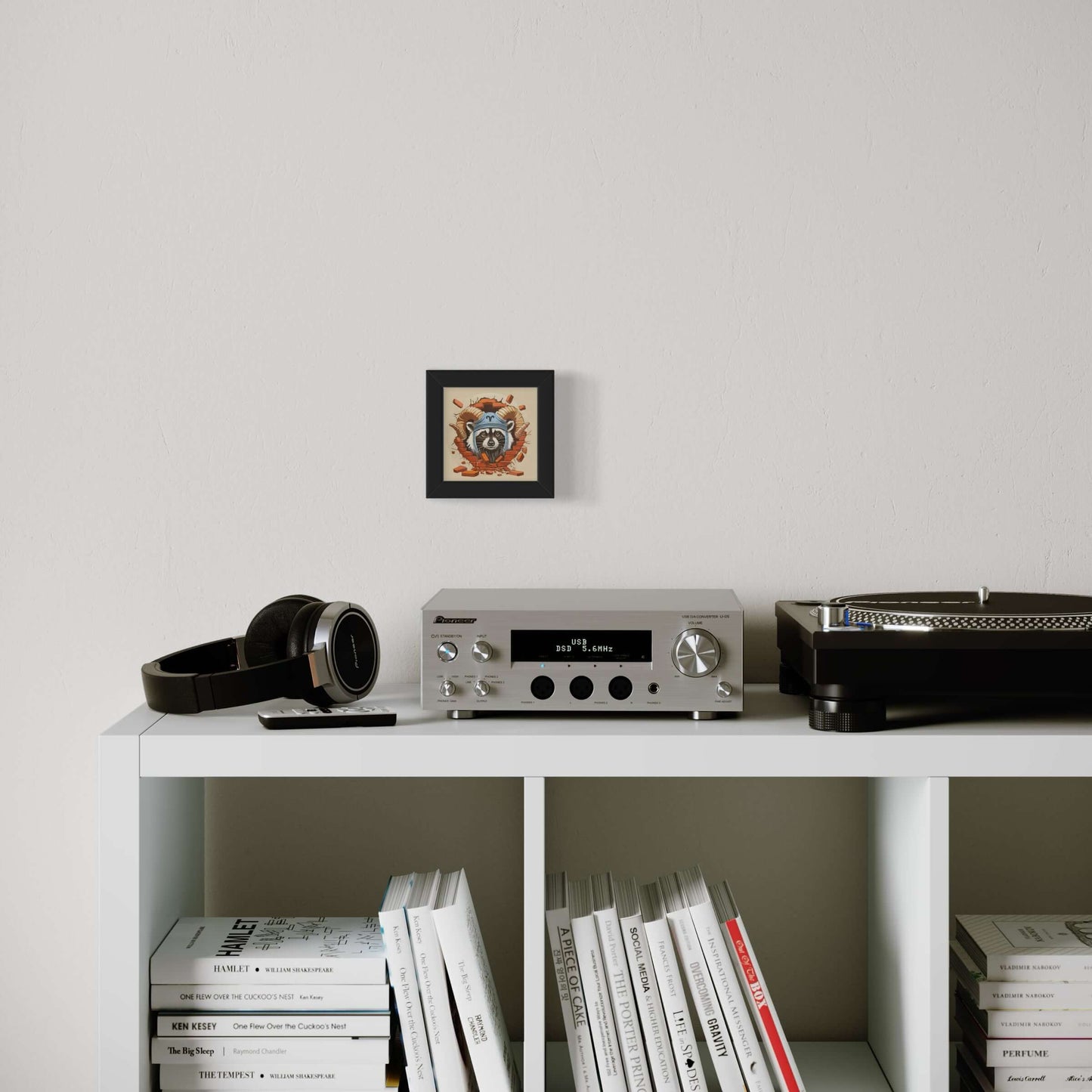 Stylish living room with framed Pocket Art, music setup, and books creating a cozy atmosphere.