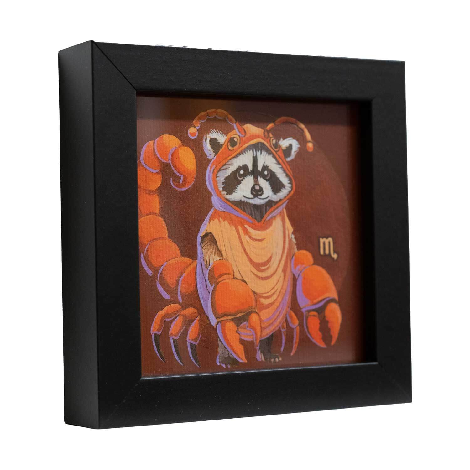 Cute raccoon in scorpion costume art print, framed in black, 10x10 cm, perfect for adding charm to any space.