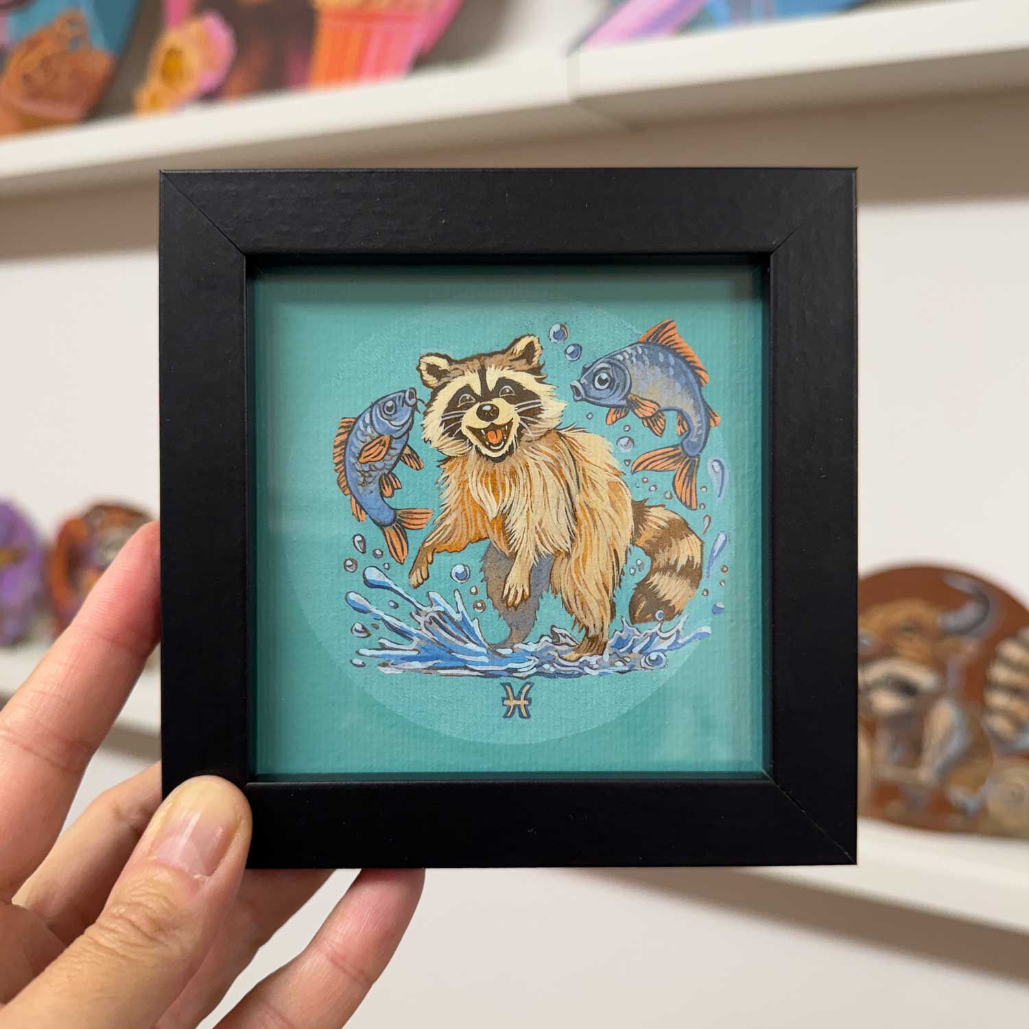 Cute framed raccoon print dancing with fish, perfect for brightening up any space!