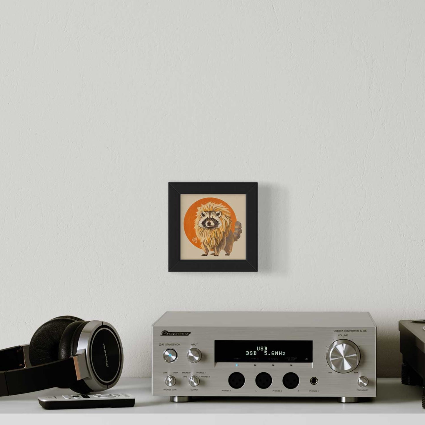 Cute pocket art print of a raccoon as a lion, framed on a wall beside a sleek audio system. Perfect for any cute décor!